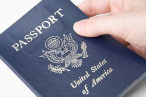 Closeup of an American passport held by a female hand.